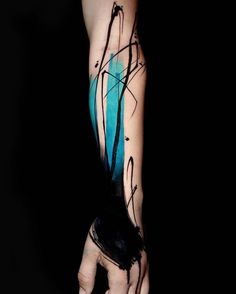 a person's arm with blue ink and black lines on it, in the dark