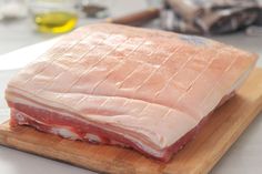 raw meat sitting on top of a wooden cutting board