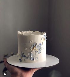 there is a white cake with blue flowers on it