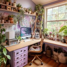 a desk with a computer on top of it next to potted plants in front of a window