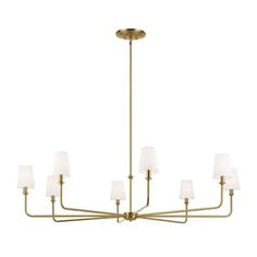 a brass chandelier with white shades