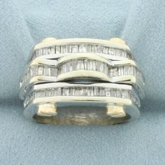 a ring with three rows of baguettes set in 18k white and yellow gold