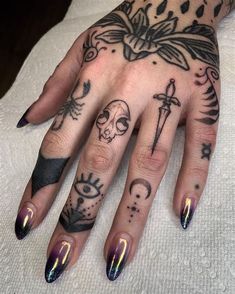 a woman's hand with tattoos on it