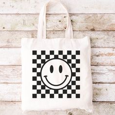 Say hello to our Checkered smiley face tote bag. This tote bag is the perfect bag to show off your cute and fun personality. All tote bags will have the option to be personalized or not which will make this bag even more worth it.  HOW TO ORDER: Please make sure to double check all info. pick your color and pick the style. MATERIAL : Our tote bags are 100% polyester Canvas, Our tote bags are also non-toxic reusable and heavy duty which make them perfect for everyday use. They are not only durabl Trendy White Square Canvas Bag, Trendy Square Cotton Canvas Bag, Canvas Bag Aesthetic, Aesthetic Smile, Summer Tote Bag, Fun Personality, Cute Envelopes, Summer Tote Bags, Bag Aesthetic