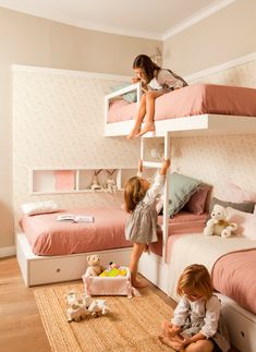 two children playing on bunk beds in a room