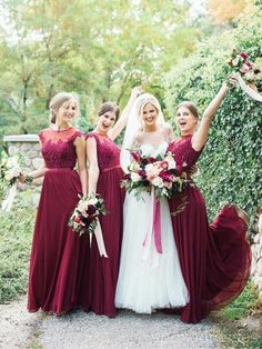 the bride and her bridesmaids are all dressed in burgundy dresses with matching bouquets