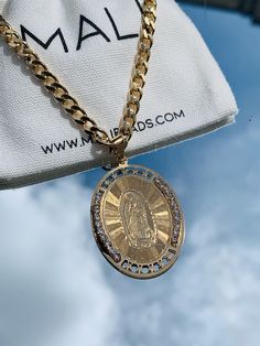 18kt Gold Filled Men's 5mm or 6mm Curb Chain Necklace with Large Virgen De Guadalupe. Pendant shipped has the Cubic Zirconia's. Please leave us a note if you want the one to the right of the image. Tarnish resistant, Hypoallergenic Pendant can slide on and off chain so the chain can also be used without the pendant. Male Model is wearing 24" Chain Female Model is wearing 14" and 16" Material: 18 Karat Gold Filled, Hypoallergenic. Tarnish Resistant. Gold-filled does not de-laminate or peel like Gold plated Jewelry nor does it tarnish as readily as silver. Generally speaking, gold filled is better quality and will have a much longer lasting color than plated jewelry. We recommend keeping abrasive chemicals away from the jewelry for the items to last. Thank you for visiting and supporting our St Jude Necklace, Saint Necklace, My Best Friend's Birthday, Mens Jewelry Necklace, Italian Jewelry, Protection Necklace, Alessandra Ambrosio, Vanessa Hudgens, Jessica Alba