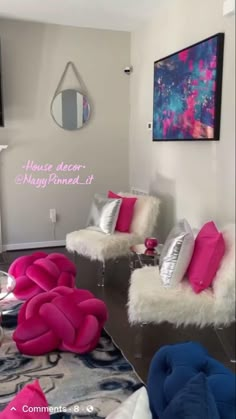 a living room filled with furniture and pink pillows