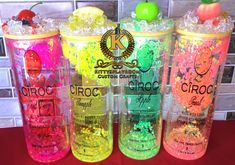 four different colored bottles with ice and fruit on the top one is labeled crocc