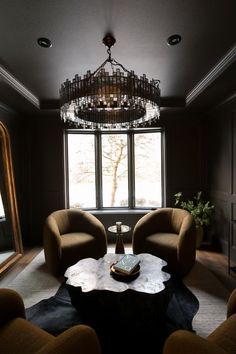 a living room filled with furniture and a chandelier