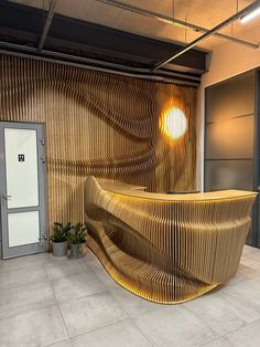 a curved wooden bench in front of a wall with an open door and potted plant