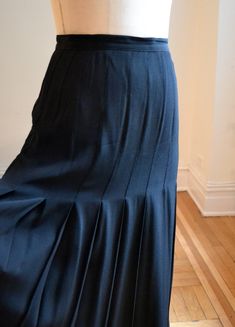 "Amazing Black Pleated skirt made in the early 90s by the true NYC designer Calvin Klein Classics . *Made in a silk satin with the crepe matte side on the outside of the skirt, satin on the inside *1\" thick waist band and 1 1/4\" pleats all around the skirt * Pleats are closed at the waist and released about 13\" down. * side zip closure and top button closure * A bit longer than your typical midi shorter than your typical maxi, please check length below, and spend some time in a skirt you love Fitted Silk Skirt With Accordion Pleats, Formal Fitted Maxi Skirt With Accordion Pleats, Fitted Maxi Skirt With Accordion Pleats For Formal Occasions, Fitted Full-length Pleated Skirt For Formal Occasions, Fitted Full Maxi Skirt With Accordion Pleats, Fitted Accordion Pleats Maxi Skirt For Formal Occasions, Silk Skirt With Accordion Pleats For Work, Silk Accordion Pleats Skirt For Work, Full Length Fitted Pleated Skirt