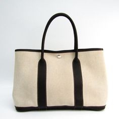 This is an , HERMES Garden Party 36 Tote Bag. It's the medium-sized GP tote. It features the natural cotton canvas with a brown calf leather trim, rolled handles, snap sides, silver-tone hardware, and a snap closure. It's a popular Hermes tote - perfect for every day. This item is in good condition, will have some noticeable signs of wear and/or use. Please view photos carefully for details. Pay close attention to sizes and measurements.Note: Our Items are totally New High quality Brand Inspired Refurbished. Please make sure you are well aware of it before buying any of the Item. T&C's Apply in case of refunds. Please send us message on below chat to confirm availability. We will send the Refurbished Model in case you place an order with us. Enjoy Shopping. Always Send Us message to confir Brown Toile, Hermes Garden Party, Hermes Handbags, Brown Canvas, Hermes Bags, Pink Top, Natural Brown, Womens Tote, Canvas Leather