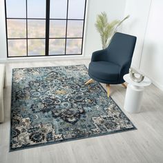 a living room with a blue chair and rug