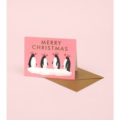 a pink christmas card with three penguins on it