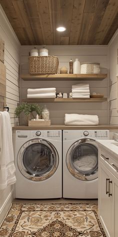 a washer and dryer in a small room with shelves on the wall above them