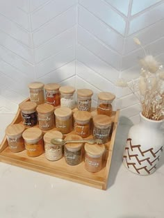 a tray filled with lots of different kinds of jams on top of a counter