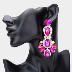 a pair of pink and white earrings on top of a mannequin's head