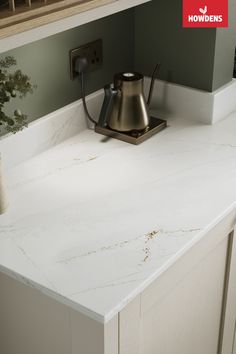 a kitchen counter with a tea pot on it