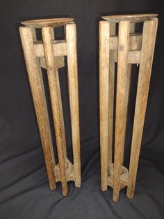 two wooden vases sitting next to each other on a black background