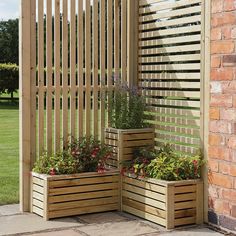 an outdoor area with wooden planters and brick walls