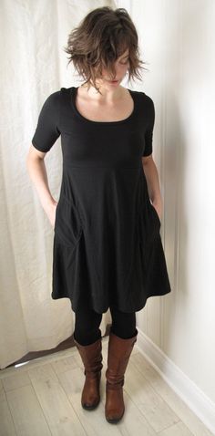 A comfortable, stylish dress, and one of our best sellers. Features a scoop neck, elbow length sleeves, and a smooth Aline skirt that sweeps out from the flattering empire waist, giving a little extra room for your belly and hips. With two side patch pockets. Made out of a silky soft bamboo/cotton/spandex fabric. Looks fantastic on it's own, or layer it over tights and boots. Shown in black. This item is made to order. Please indicate your size and colour choice when you purchase. Allow 3-5 week Solid Color Fitted Dress For Everyday Wear, Casual Fitted A-line Short Sleeve Dress, Casual Scoop Neck Everyday Dress, Stretch Solid Dresses For Everyday Wear, Stretch Solid Dress For Everyday Wear, Everyday Stretch Solid Dresses, Everyday Solid Stretch Dresses, Black Relaxed Fit Dress For Everyday, Solid Color Short Sleeve Everyday Dresses