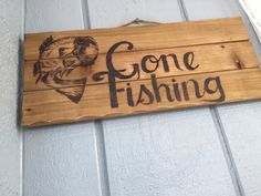 a wooden sign that says gone fishing on it