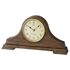 a small wooden clock with roman numerals