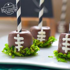 chocolate covered football candies with white and black striped straws