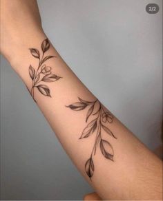 a woman's arm with leaves on it