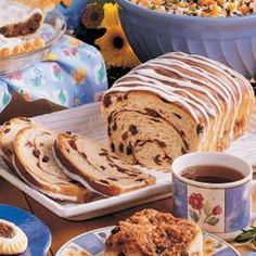 a table topped with lots of food next to cups and saucers filled with desserts