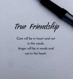 a pen sitting on top of a piece of paper with the words true friendship