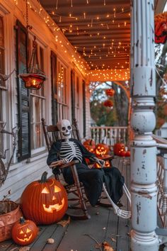 a skeleton sitting in a rocking chair on the porch with jack - o'- lanterns