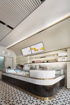 the interior of a restaurant with marble counter tops and black and white tile flooring