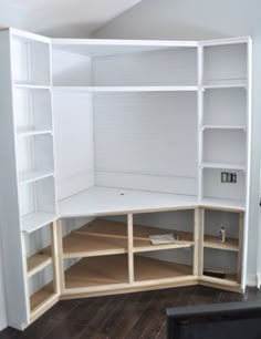 a white bookcase with shelves and drawers on it