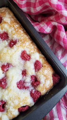 a pan filled with raspberry bread on top of a pink and white checkered cloth