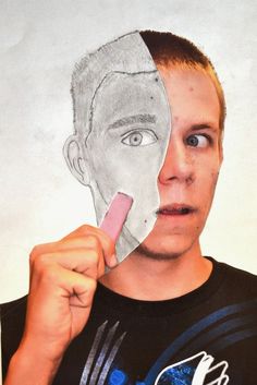 a man is holding up a paper cut out of the face of a person with a pencil in his mouth