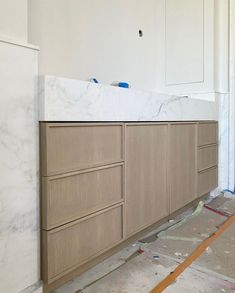 an unfinished kitchen with marble counter tops and cabinets