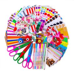 many different colored scissors and stickers on a white surface