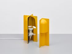 a white toilet sitting inside of a yellow box