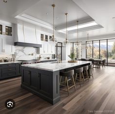 a large kitchen with an island in the middle and lots of counter space on each side