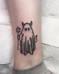 a black and white image of a ghost with an arrow tattoo on the ankle area