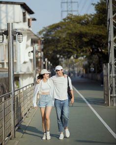 a man and woman walking down the street