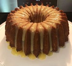 a bundt cake with icing on a white plate