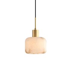 a white and gold colored pendant light hanging from a black cord on a white wall