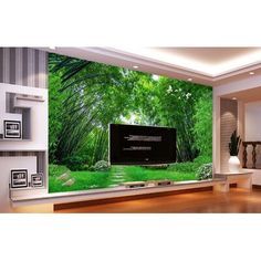 a living room with a large tv on the wall and green trees in the background