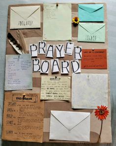 a bulletin board with letters, papers and envelopes on it that read prayer board