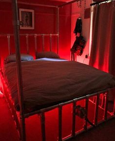 a bed in a room with red lights