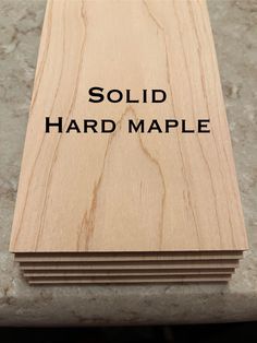 the words solid hard maple are on top of several pieces of plywood planks