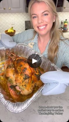 a woman holding up a roasting pan with a turkey in it